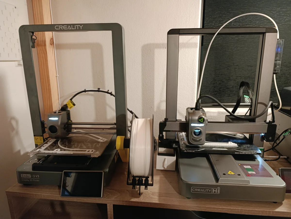 Shay's original Creality Ender 3 V3 (left) next to the Creality Hi Combo (right) that followed it