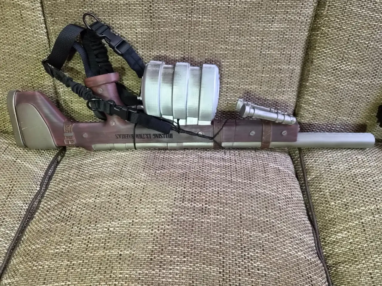 The other side of the Harkonnen, with the Hellsing 13.7mm lettering along the wood-effect stock and a black two-point sling attached