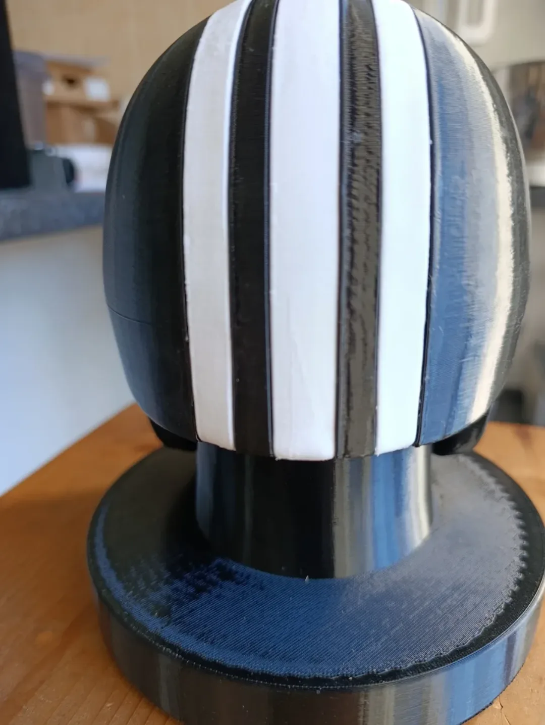 Close-up of the Killa helmet showing the silver rivets along the visor line and white stripe detail