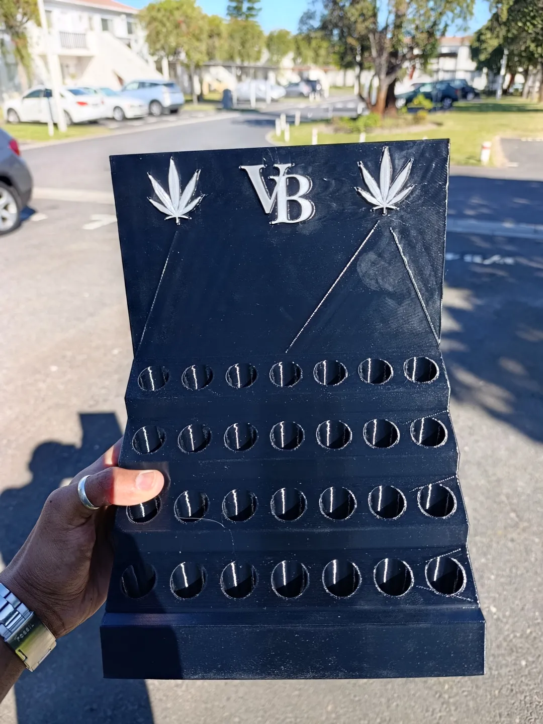 Velvet Burn pre-roll display stand photographed from a low angle in the store, green cannabis leaf neon sign glowing in the background