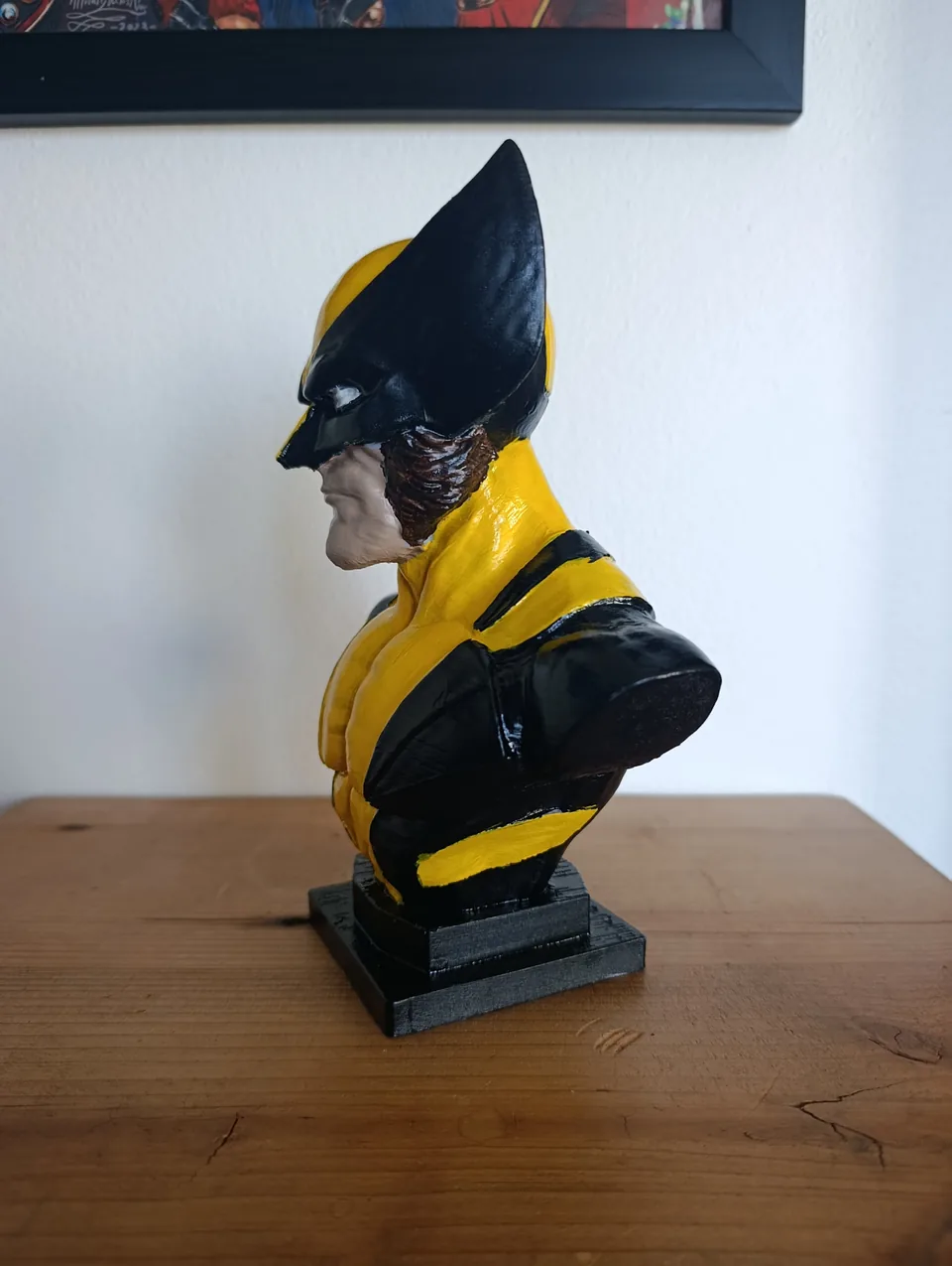The Wolverine bust in profile from the other side, with the sharp cowl fin and gloss black suit
